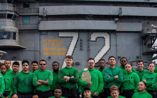 Abraham Lincoln’s catapult crew poses on the flight deck